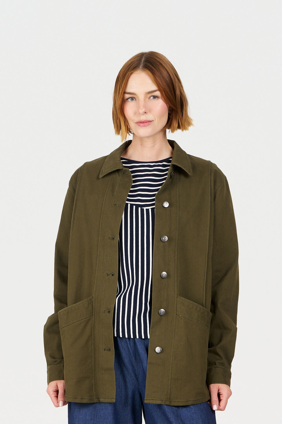 Model wearing CHORE Organic Cotton Jacket - khaki over a striped top, showcasing a stylish and sustainable fashion choice.