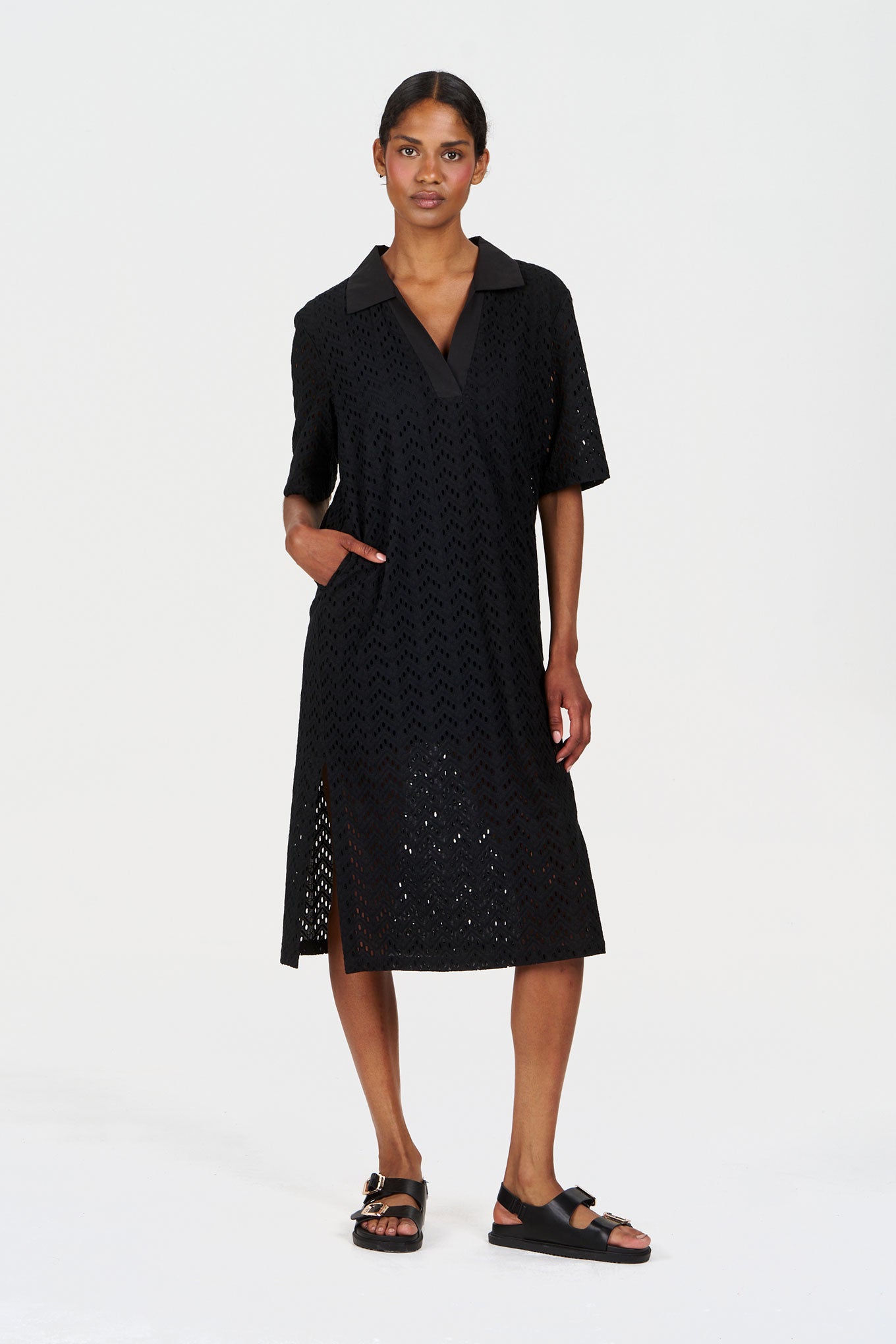 DELILAH Organic Cotton Dress - Black model wearing a stylish black dress with pockets and a collar, showcasing a relaxed fit.