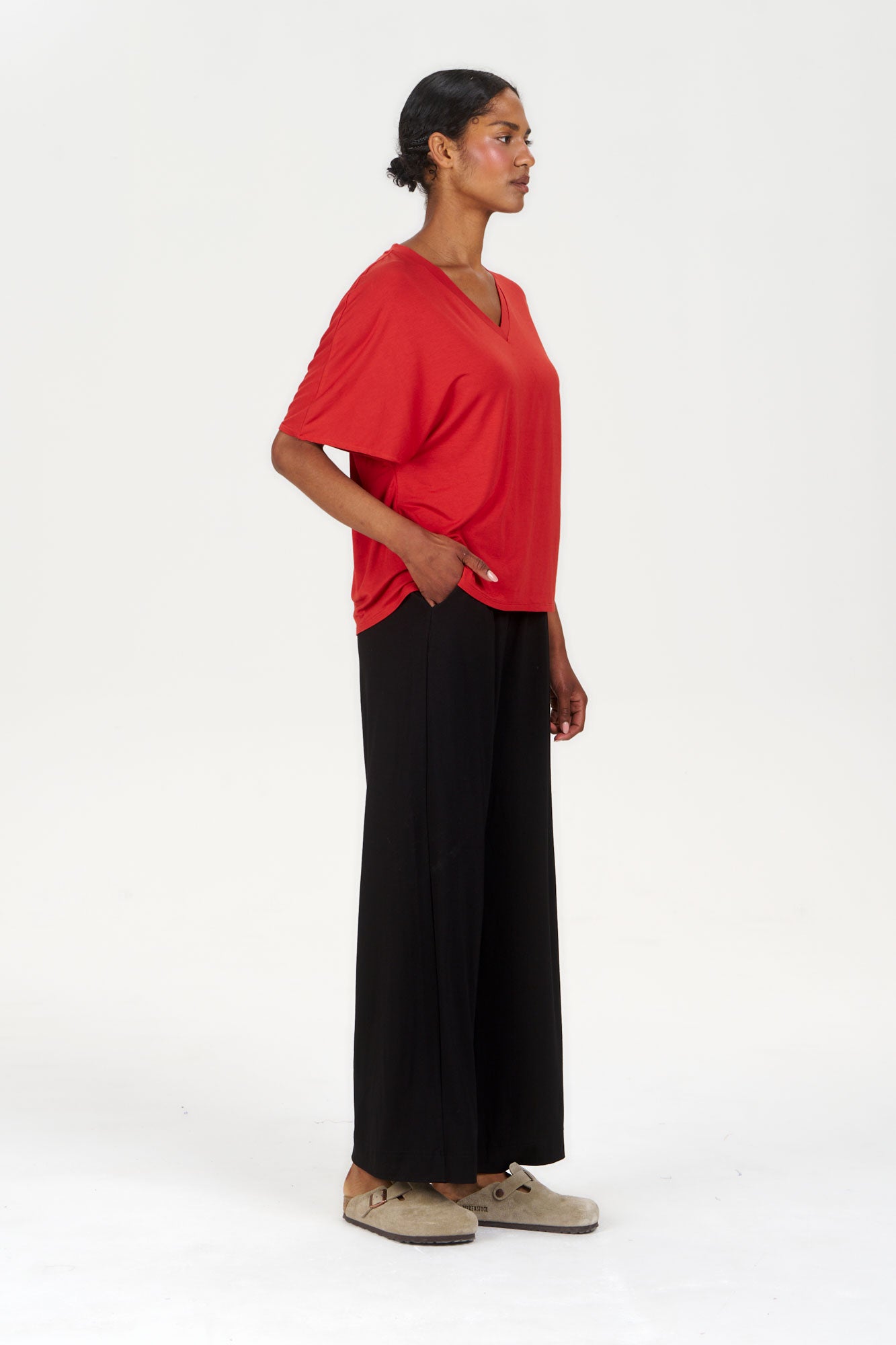 Model wearing BINITA Modal Trouser - Black paired with a red top, showcasing a stylish casual look.