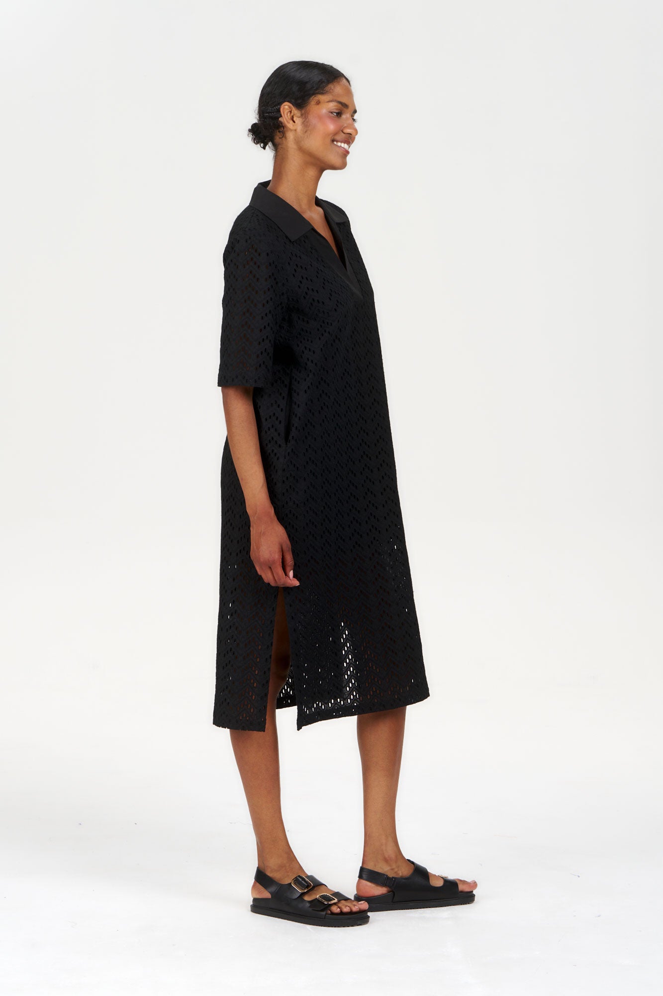 Model wearing a DELILAH Organic Cotton Dress - Black, featuring a relaxed fit and side slits, showcasing sustainable fashion.