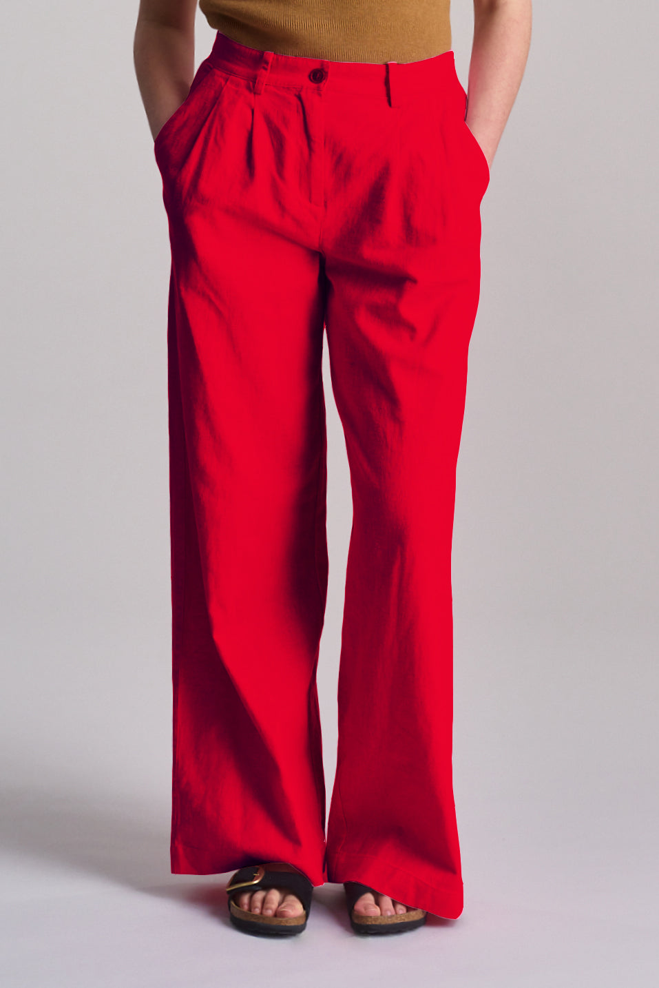 Lion Tencel Linen Trouser - Coral worn by a model, featuring a relaxed fit and vibrant coral color.