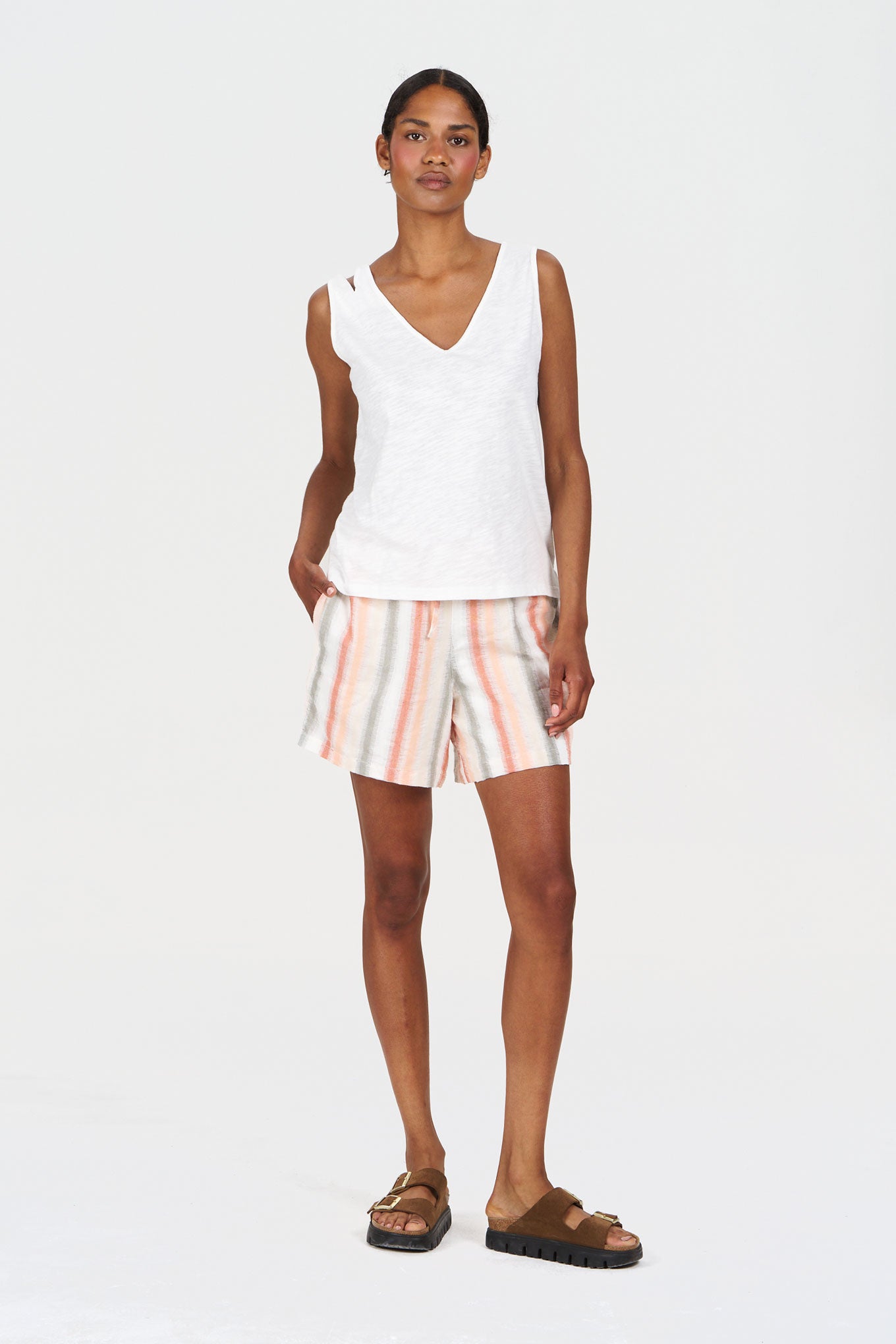 Model wearing GRACE Organic Cotton Short - Stripe with a white top and sandals on a plain background.