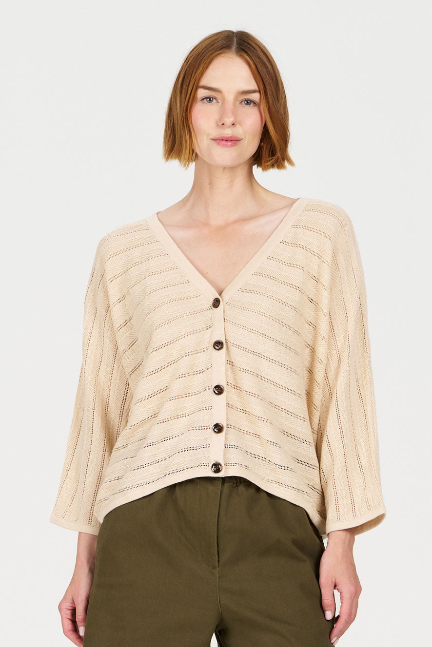 MALI Organic Ramie Cotton Batwing Cardigan - Sand worn by a model, featuring a relaxed fit and buttons.