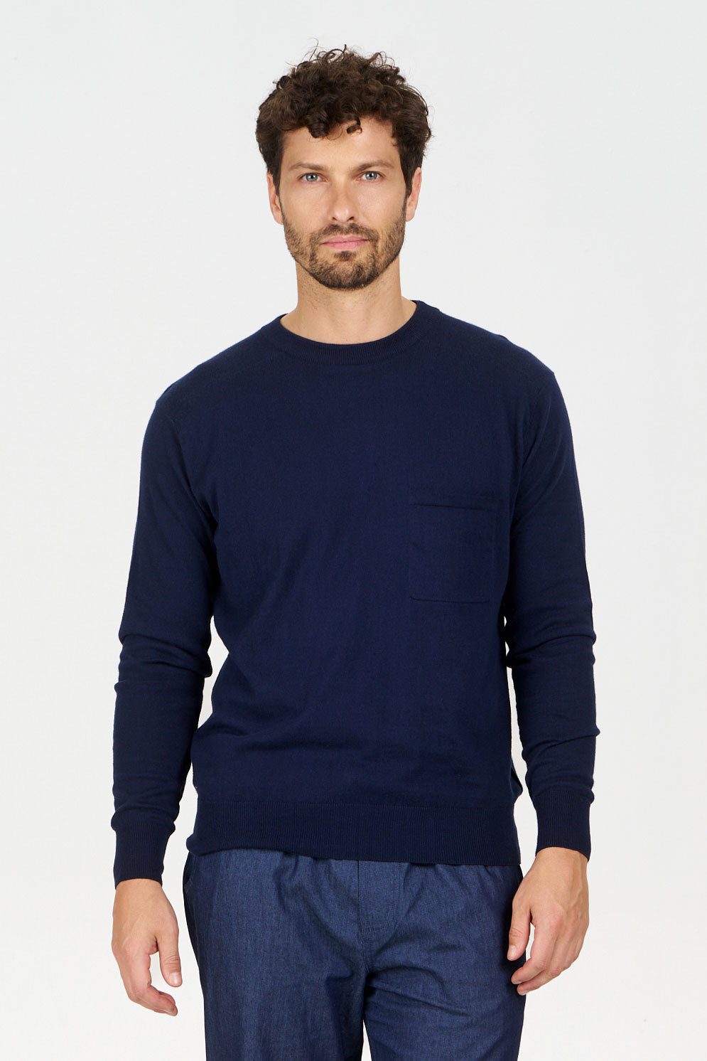 Man wearing POCKET GOTS Organic Cotton Jumper navy, featuring a relaxed fit and chest pocket, made from 100% organic cotton.