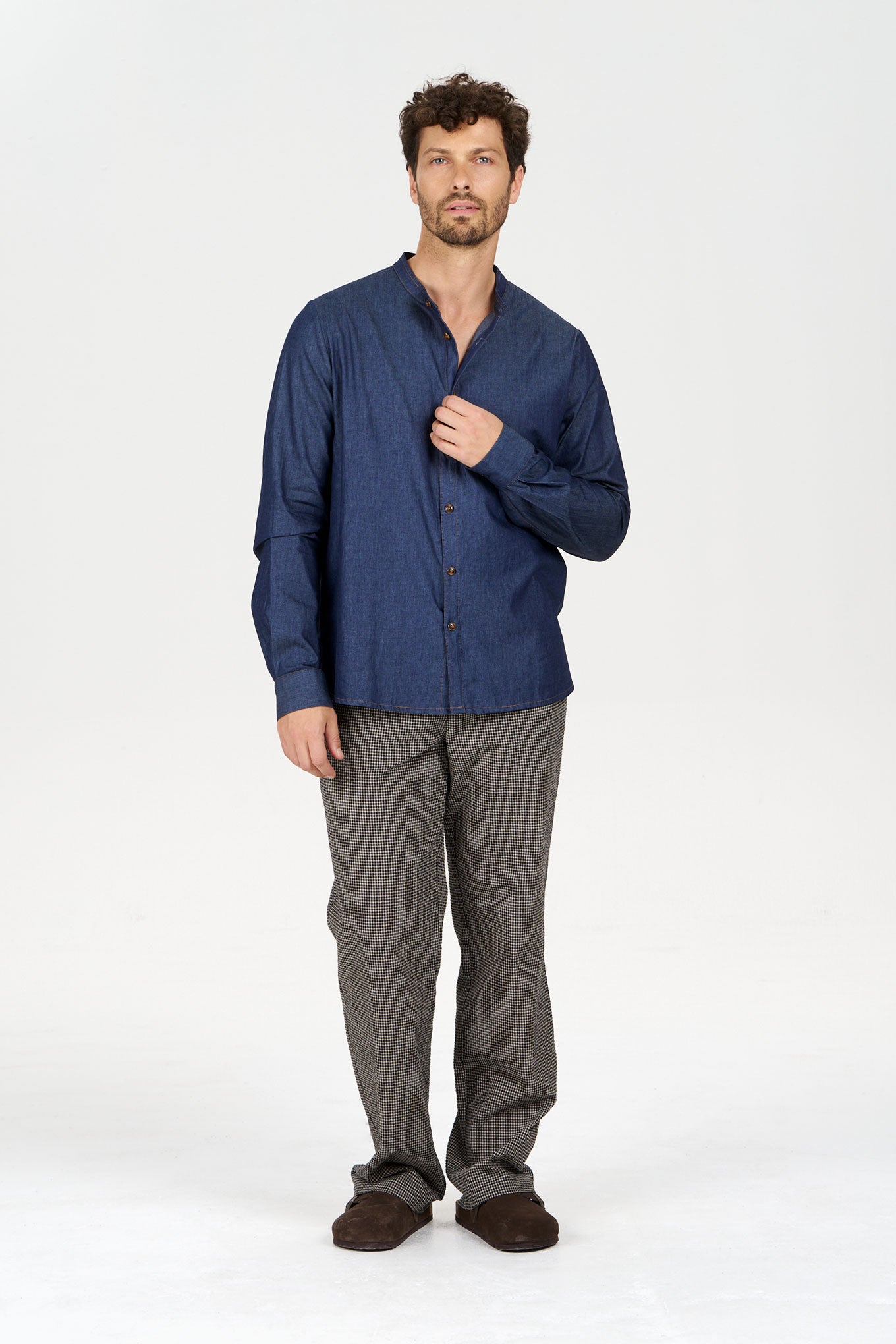 Model wearing ROBBIE Organic Cotton Chambray Shirt with denim look, paired with stylish trousers.
