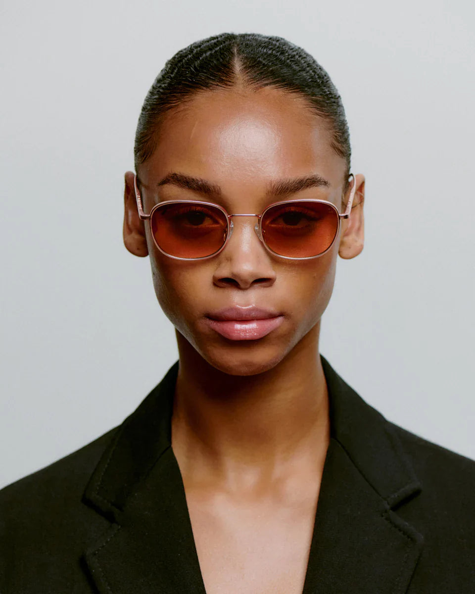 HELLO - Rosegold Sunglasses by A.Kjaerbede, worn by a model showcasing the sleek design and stylish appeal.
