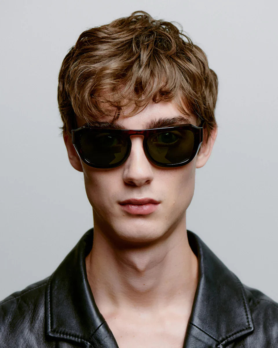 MAX - Demi Tortoise Sunglasses by A.Kjaerbede worn by a model with stylish hair against a neutral background.