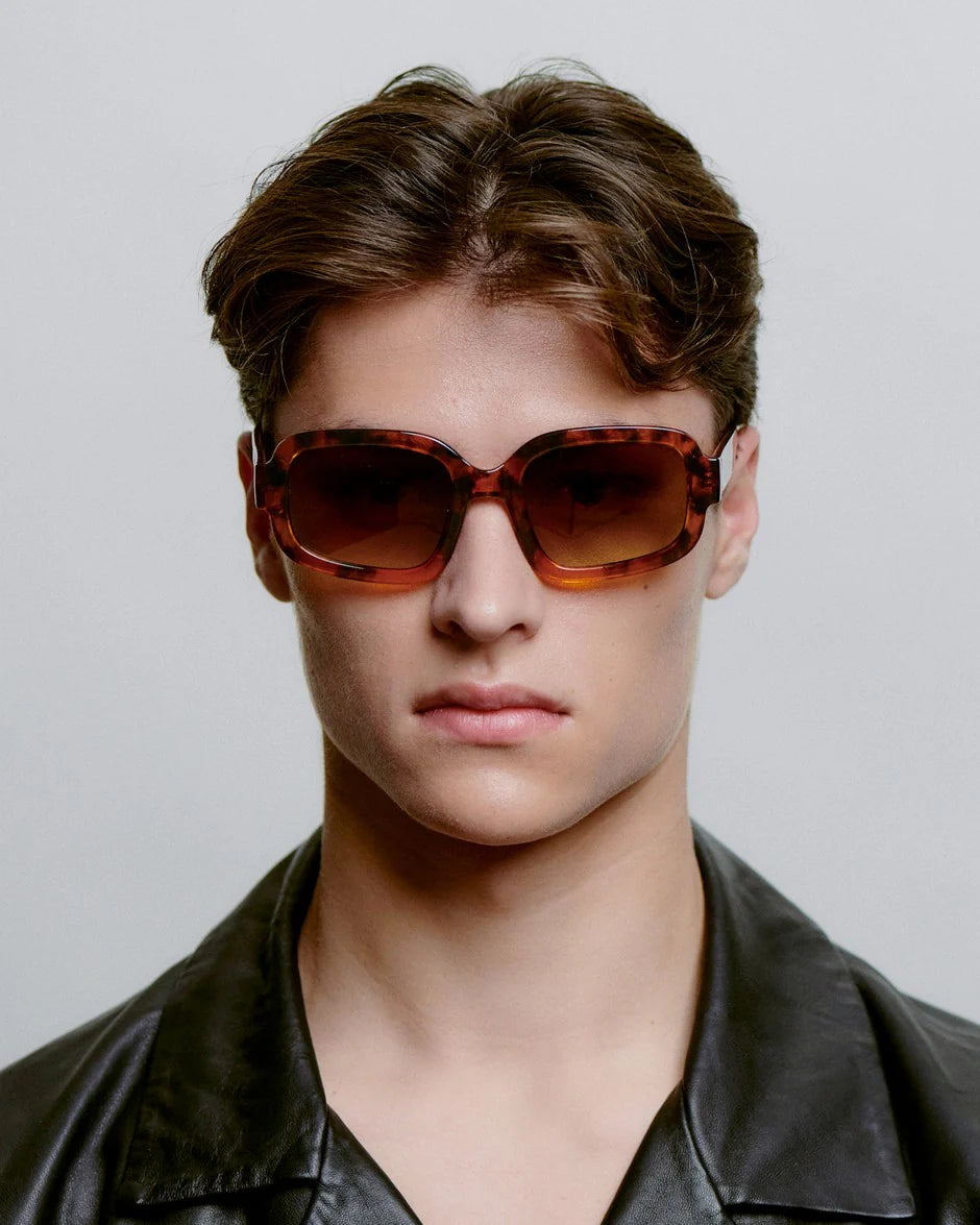 PLUTO - Havana Sunglasses by A.Kjaerbede worn by a model showcasing the oversized silhouette and vintage glamor.