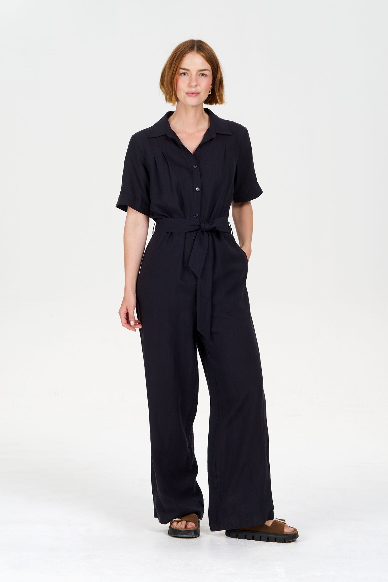 Model wearing the AMARIE Tencel Linen Jumpsuit in navy, showcasing a stylish and comfortable fit.