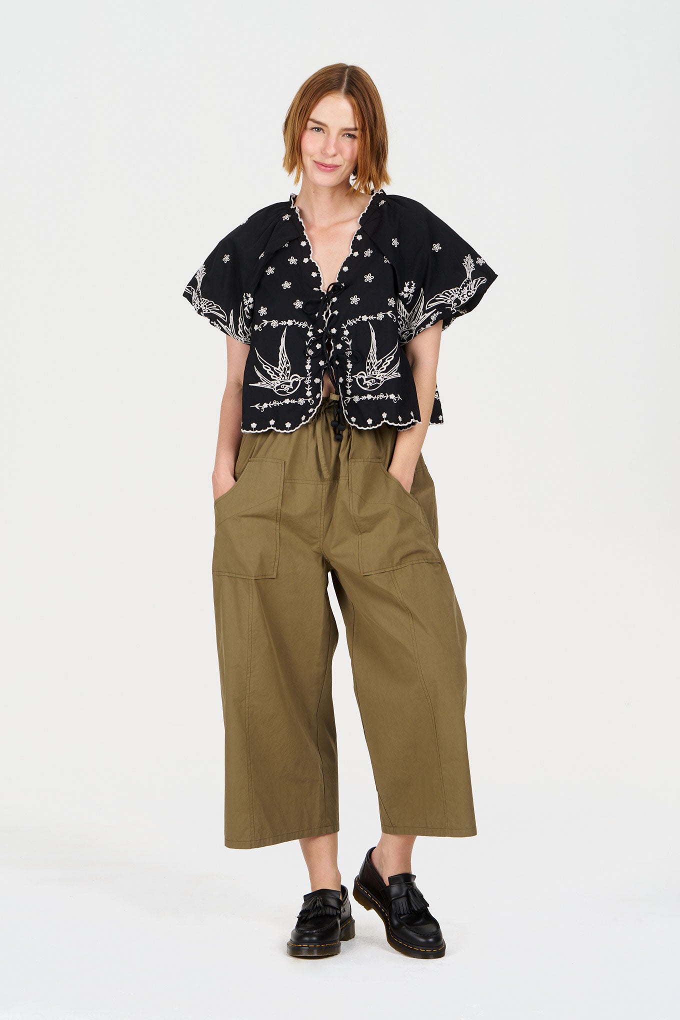 Model wearing CLEO Organic Cotton Trouser - Khaki with a black patterned top, showcasing relaxed casual style.
