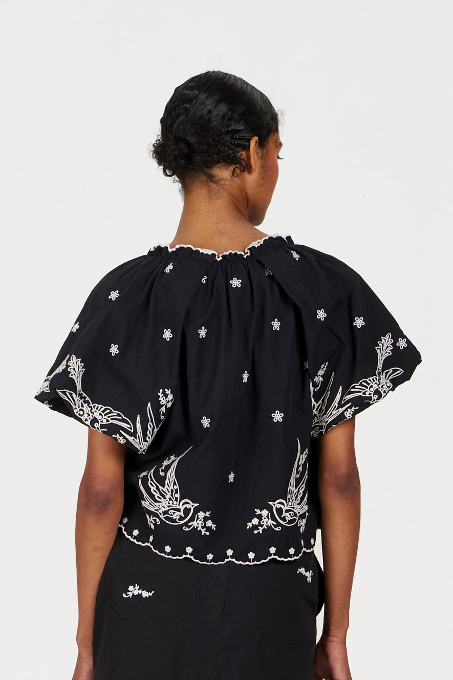 BEATRIX Organic Cotton Top - Black showcasing intricate bird embroidery on the back, emphasizing its organic cotton design.