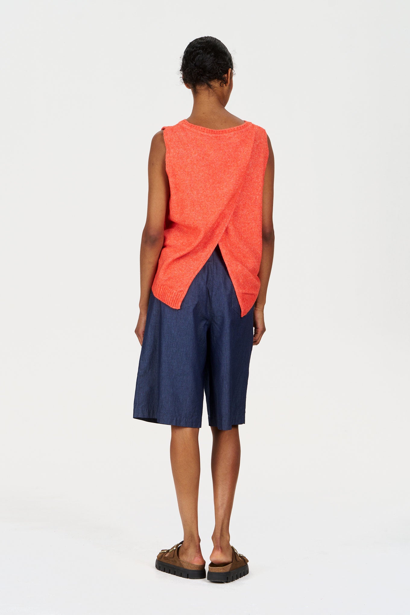 Model wearing LIV Organic Cotton Short - midwash with an orange top, showcasing a stylish and sustainable outfit.