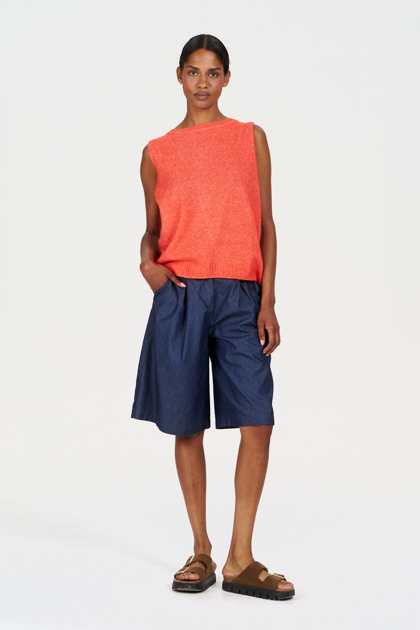 Model wearing LIV Organic Cotton Short - midwash with a bright orange sleeveless top and casual sandals.