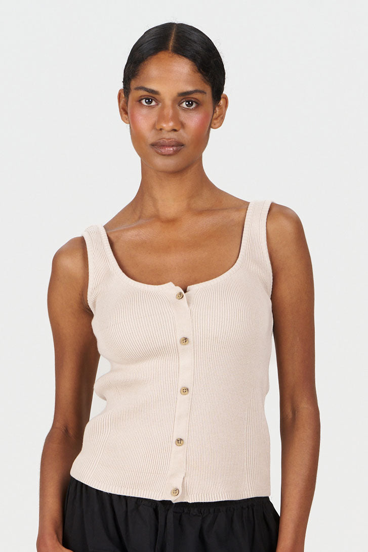 Model wearing COVE Vest Organic Cotton Vest - Sand featuring a button-up front and ribbed design.