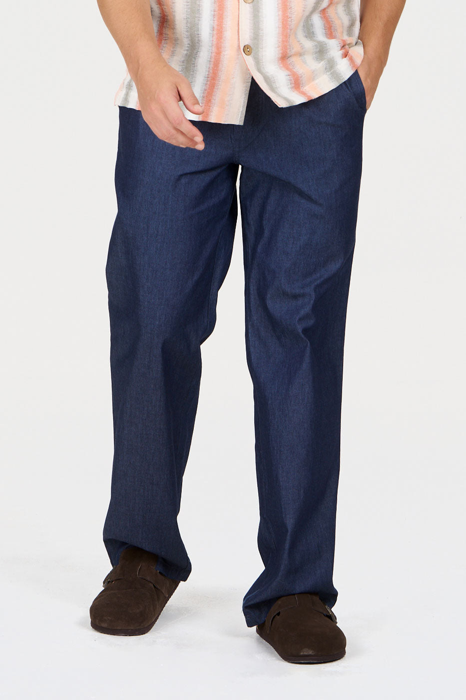 JOSHUA Organic Cotton Trouser - Mid Wash showcased in a casual outfit with a patterned shirt.
