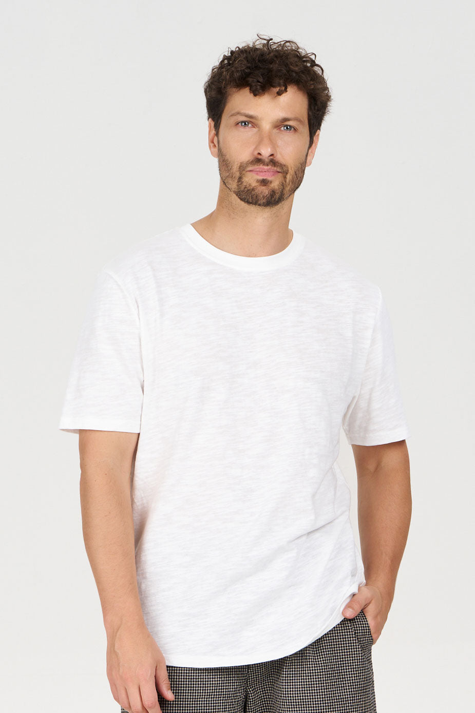 Model wearing KIN Organic Cotton Tee - White, showcasing its soft fabric and casual style.