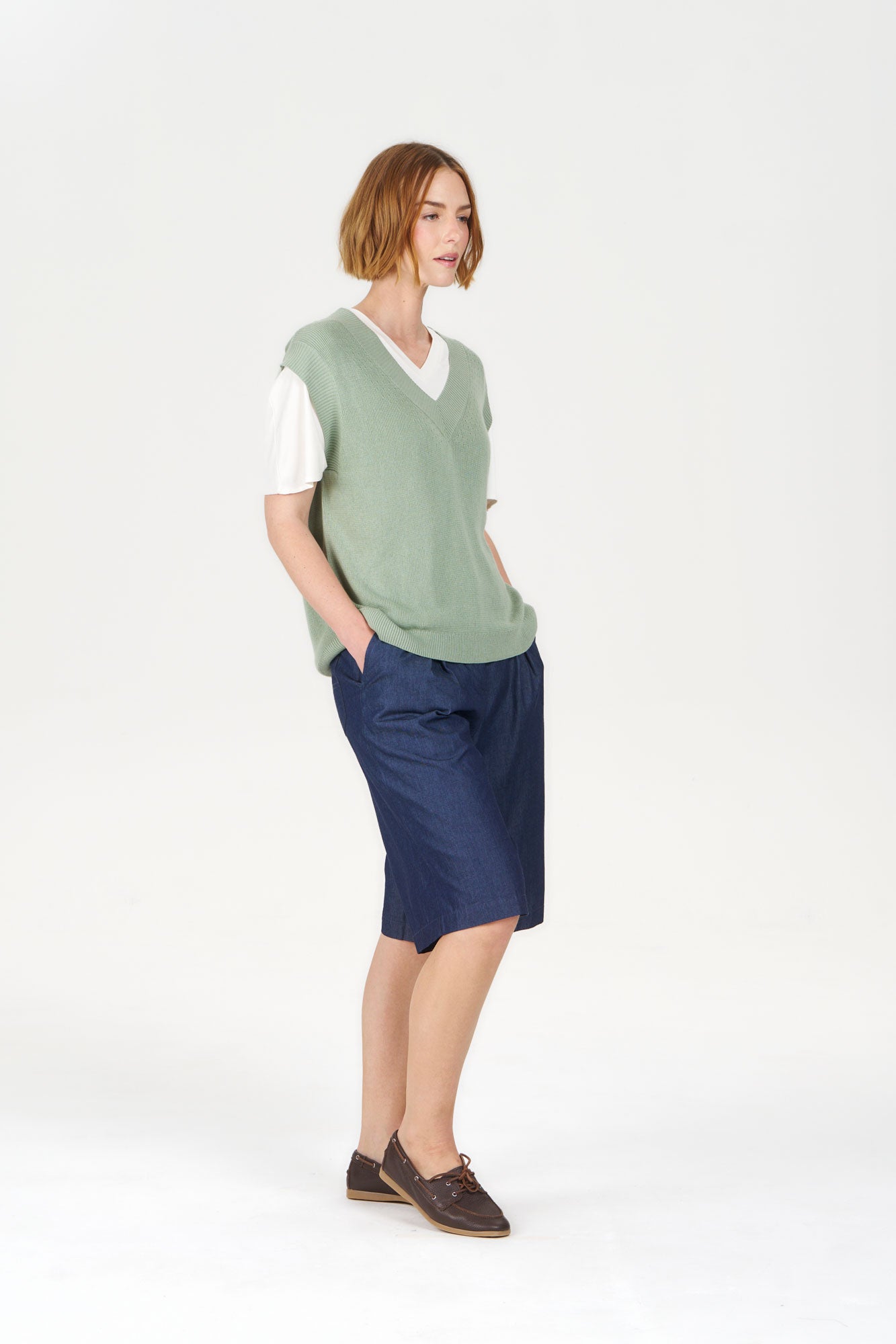 SANDER Organic Ramie Cotton Vest - Sage worn with a white shirt and blue skirt, showcasing a casual and eco-friendly style.