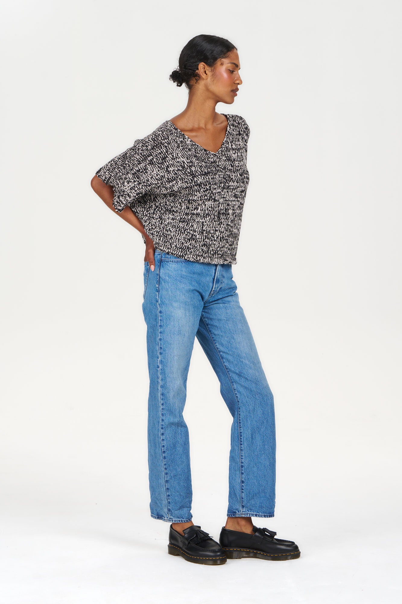 Model wearing TERESA Organic Cotton Jumper - Black & White with blue jeans and black shoes.
