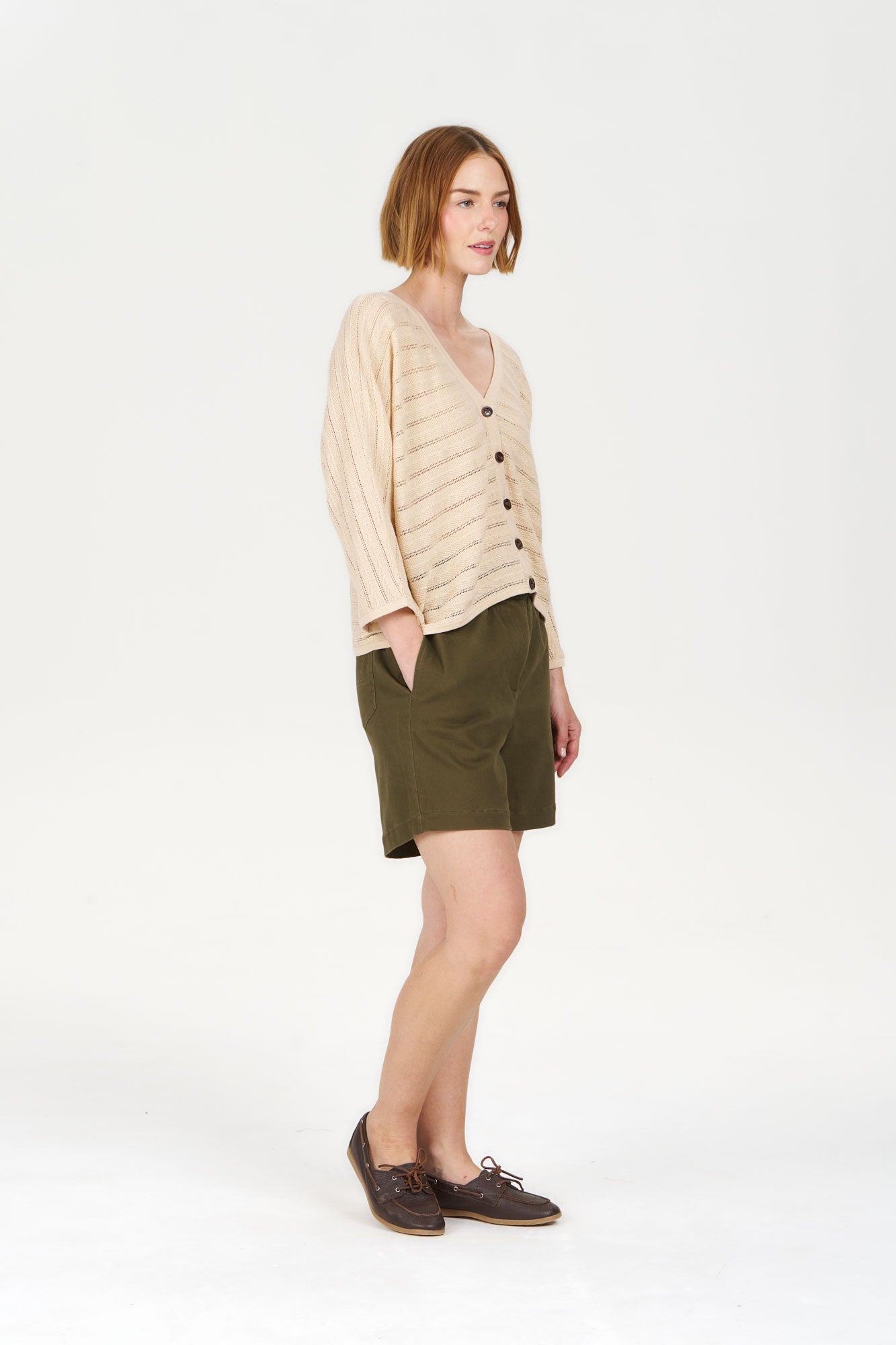 MALI Organic Ramie Cotton Batwing Cardigan - Sand worn with shorts and shoes, showcasing a relaxed silhouette.