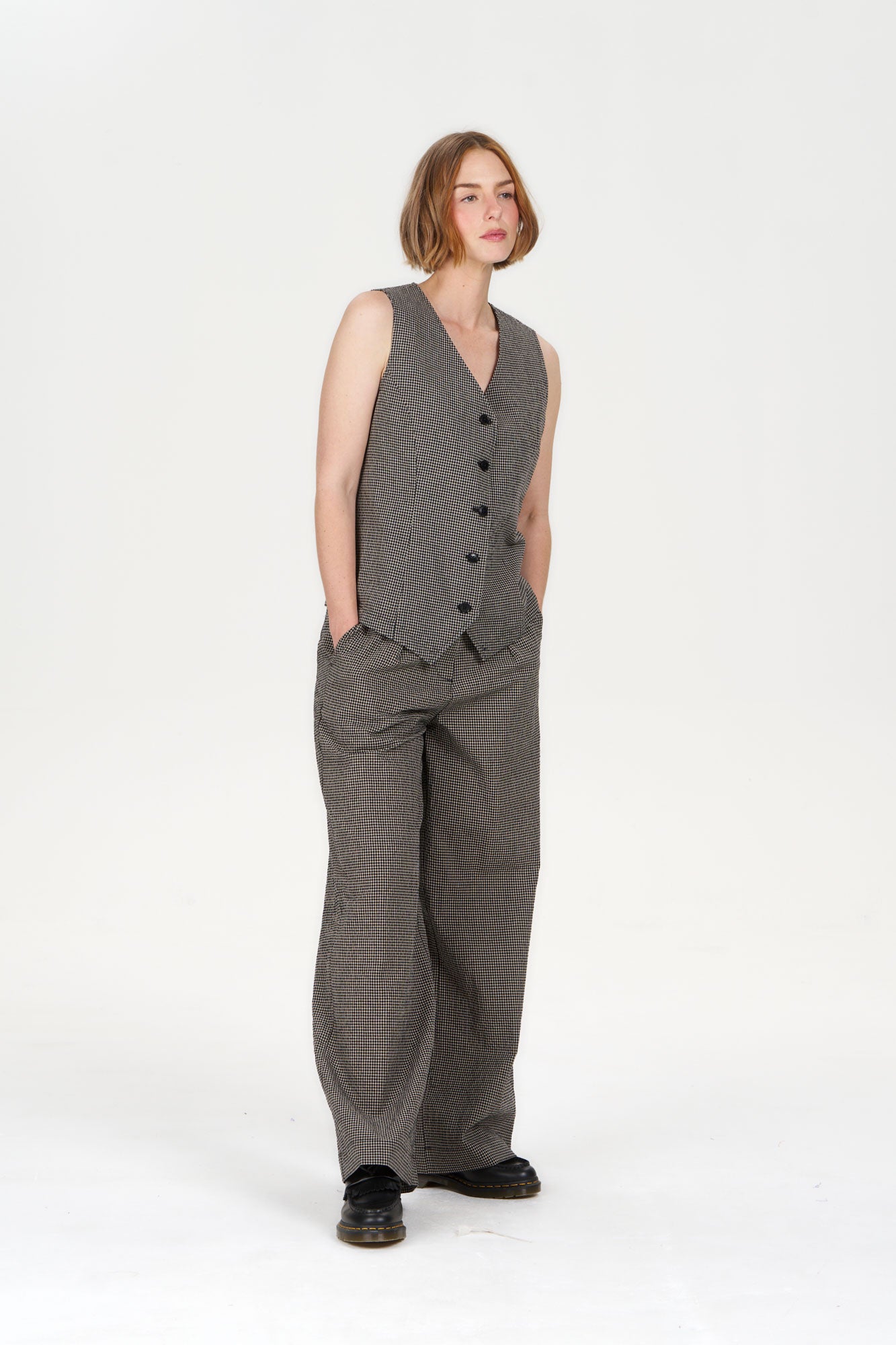 TESSA Organic Cotton Vest - check, modeled by a woman in a stylish gray outfit, showcasing sustainable fashion.