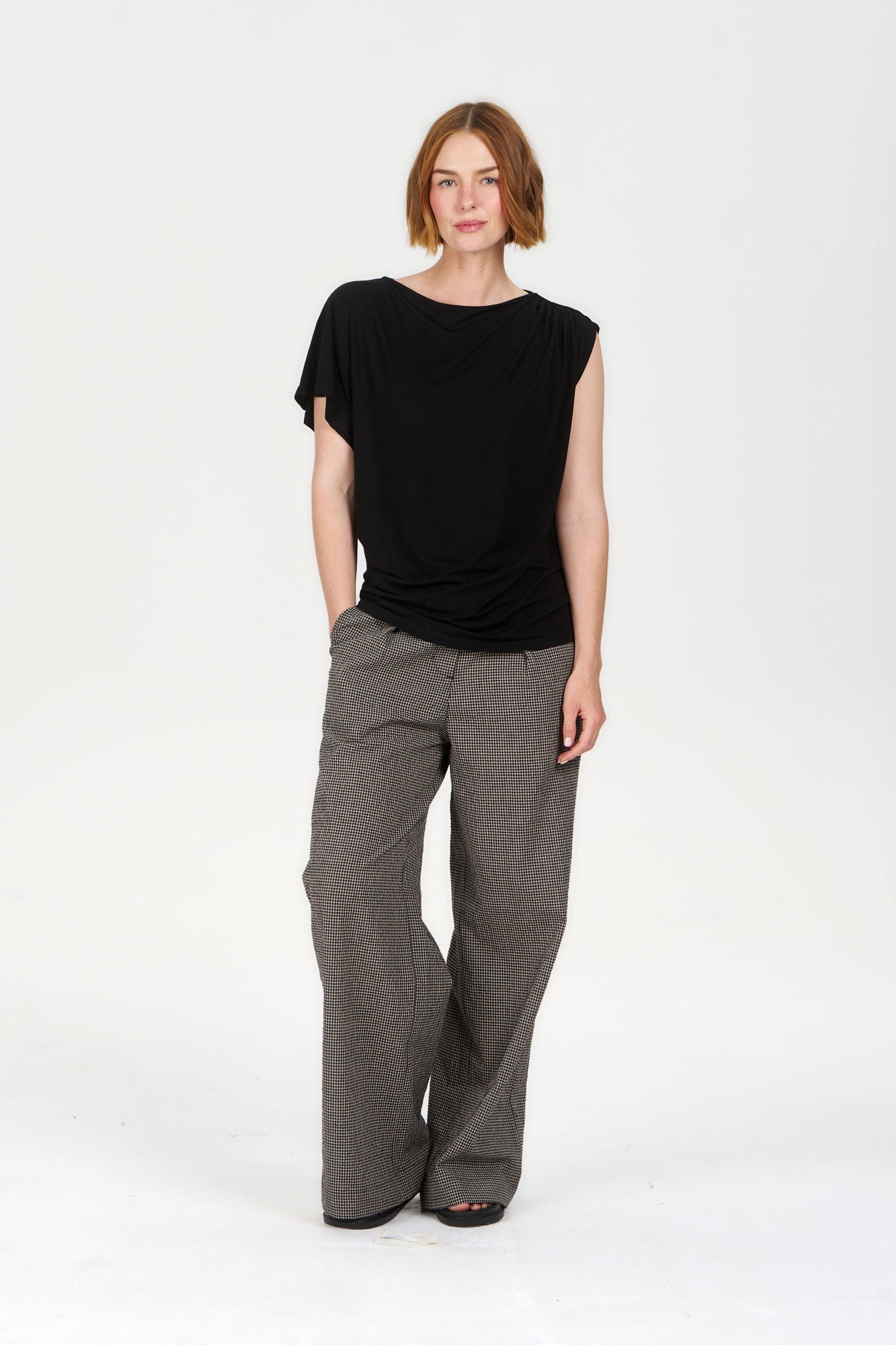 Model wearing CATE Modal Top - Black paired with wide-leg pants, showcasing a stylish and comfortable outfit.