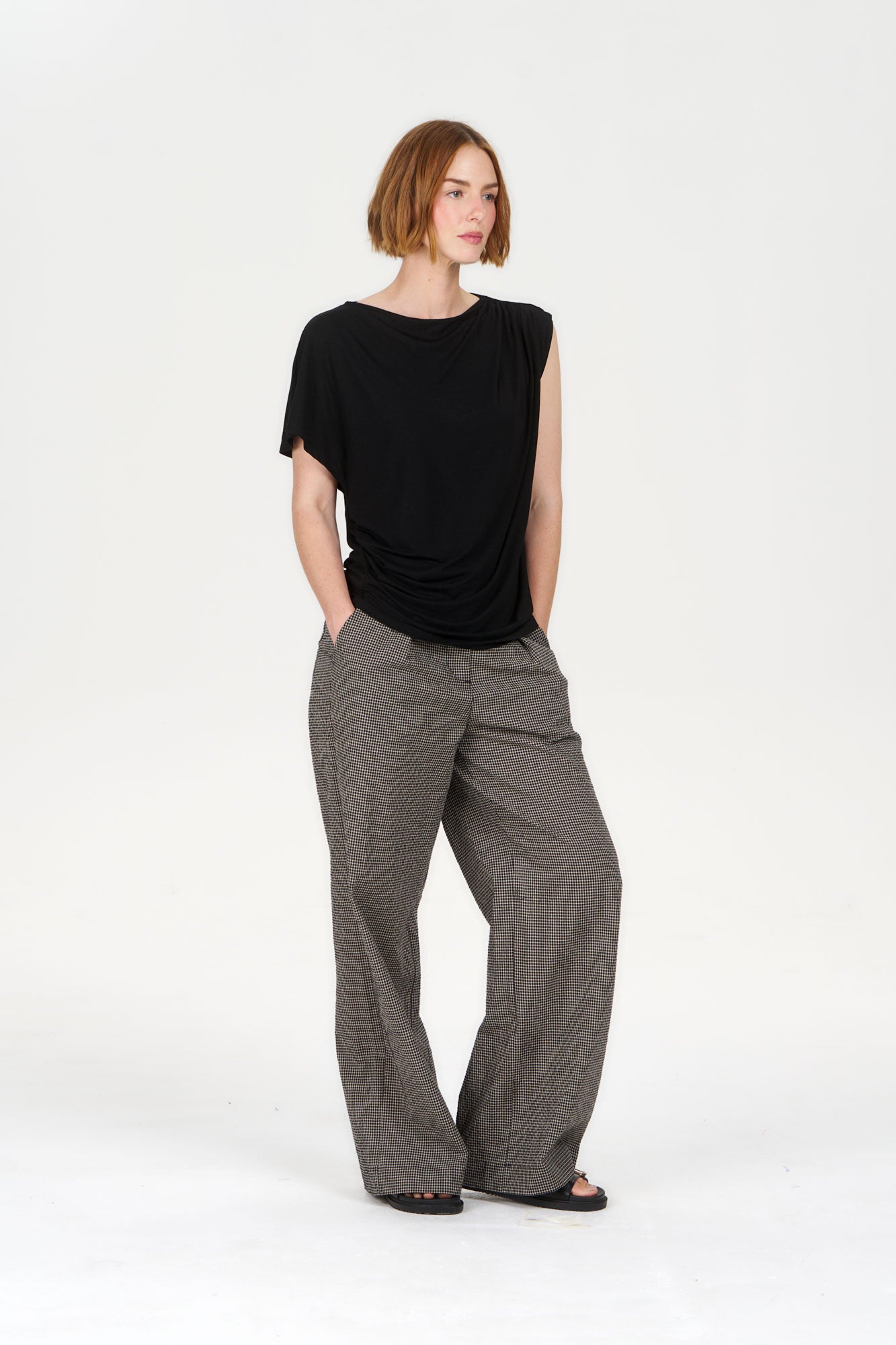 Model wearing CATE Modal Top - Black with wide-leg patterned pants, showcasing a stylish, modern outfit.