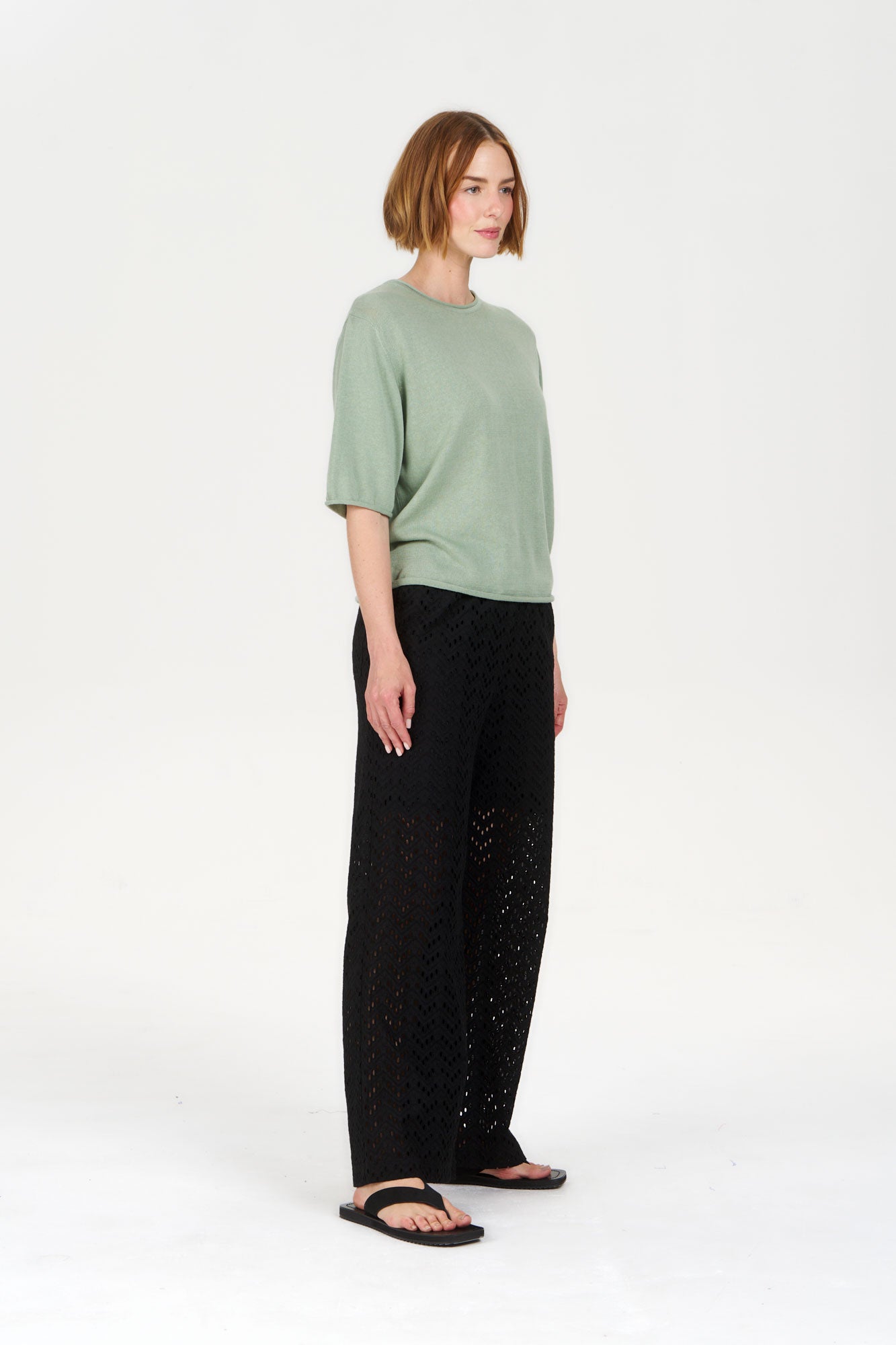 Model wearing CAMILLE Organic Ramie Cotton Tee - Sage with black pants and sandals.