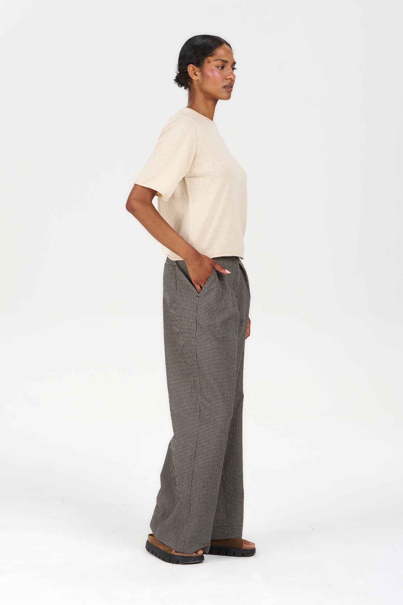 Model wearing CAMILLE Organic Linen Cotton Tee - Almond with loose patterned pants, showcasing a casual and stylish look.