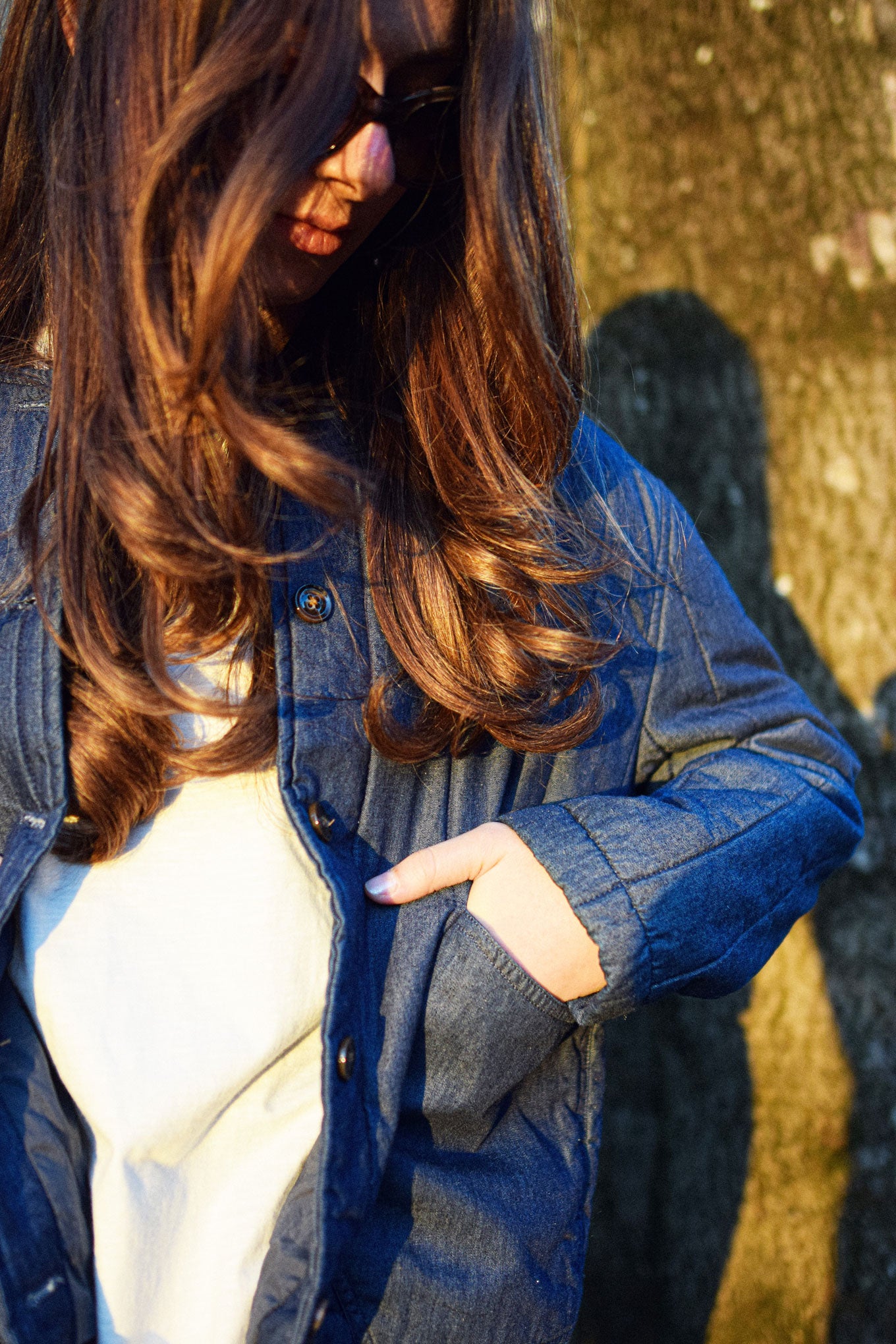 Woman wearing LOTTIE Organic Cotton Jacket - midwash, showcasing its style and comfort in natural light.