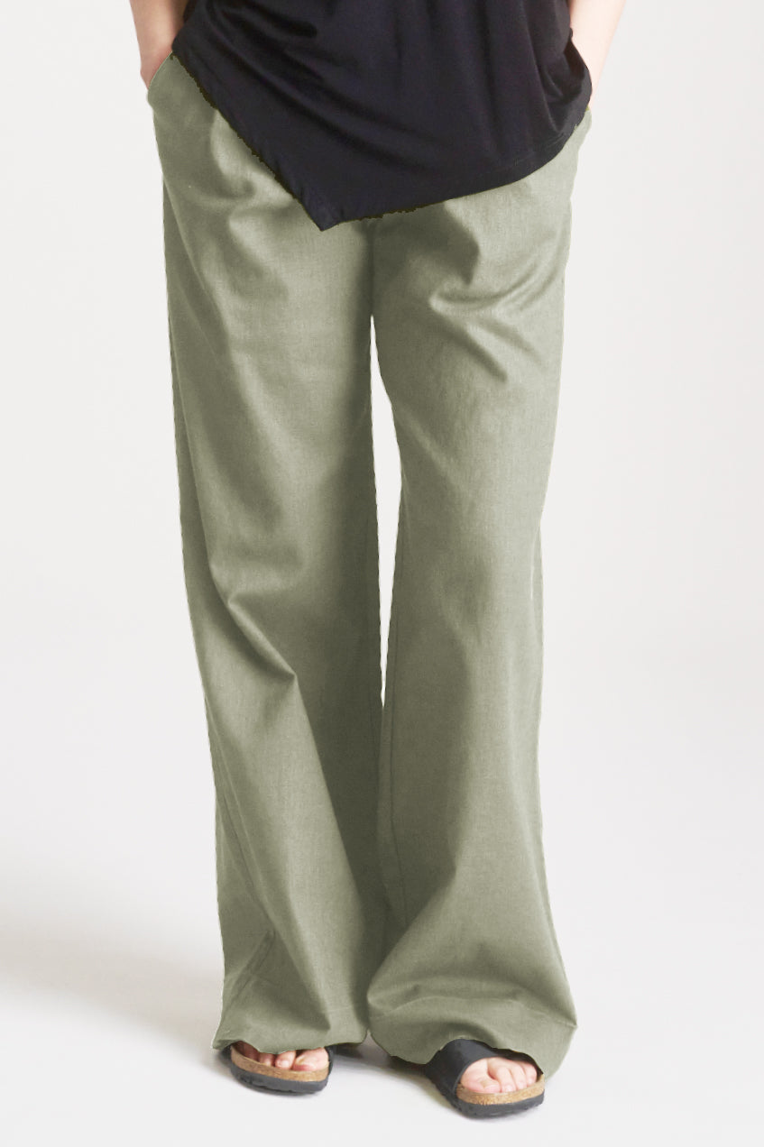 LION Tencel Linen Trouser Sage displayed on model, featuring relaxed tailoring in breathable fabric blend.