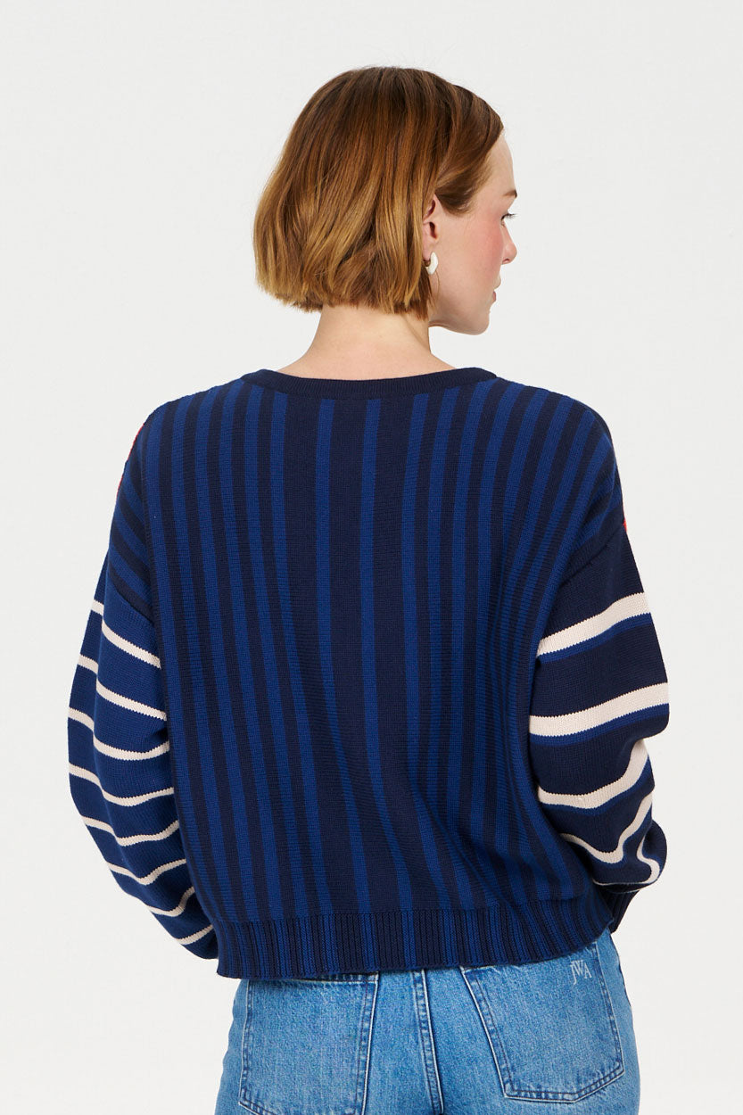 Back view of a person wearing a MISH MASH Organic Cotton Cardigan with navy and stripe design.
