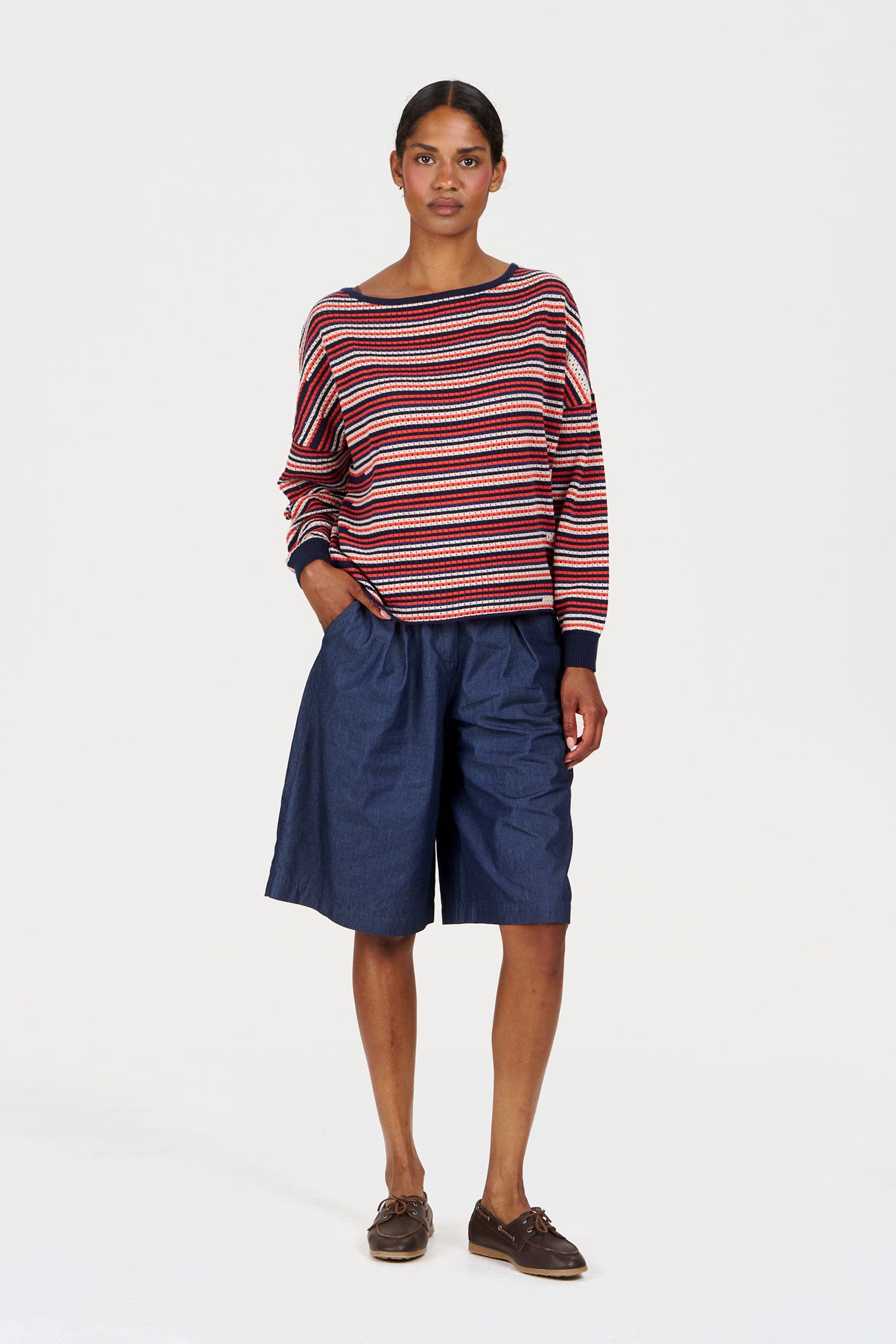 PINA Organic Cotton Jumper worn by a model with striped design paired with dark shorts on a plain background.