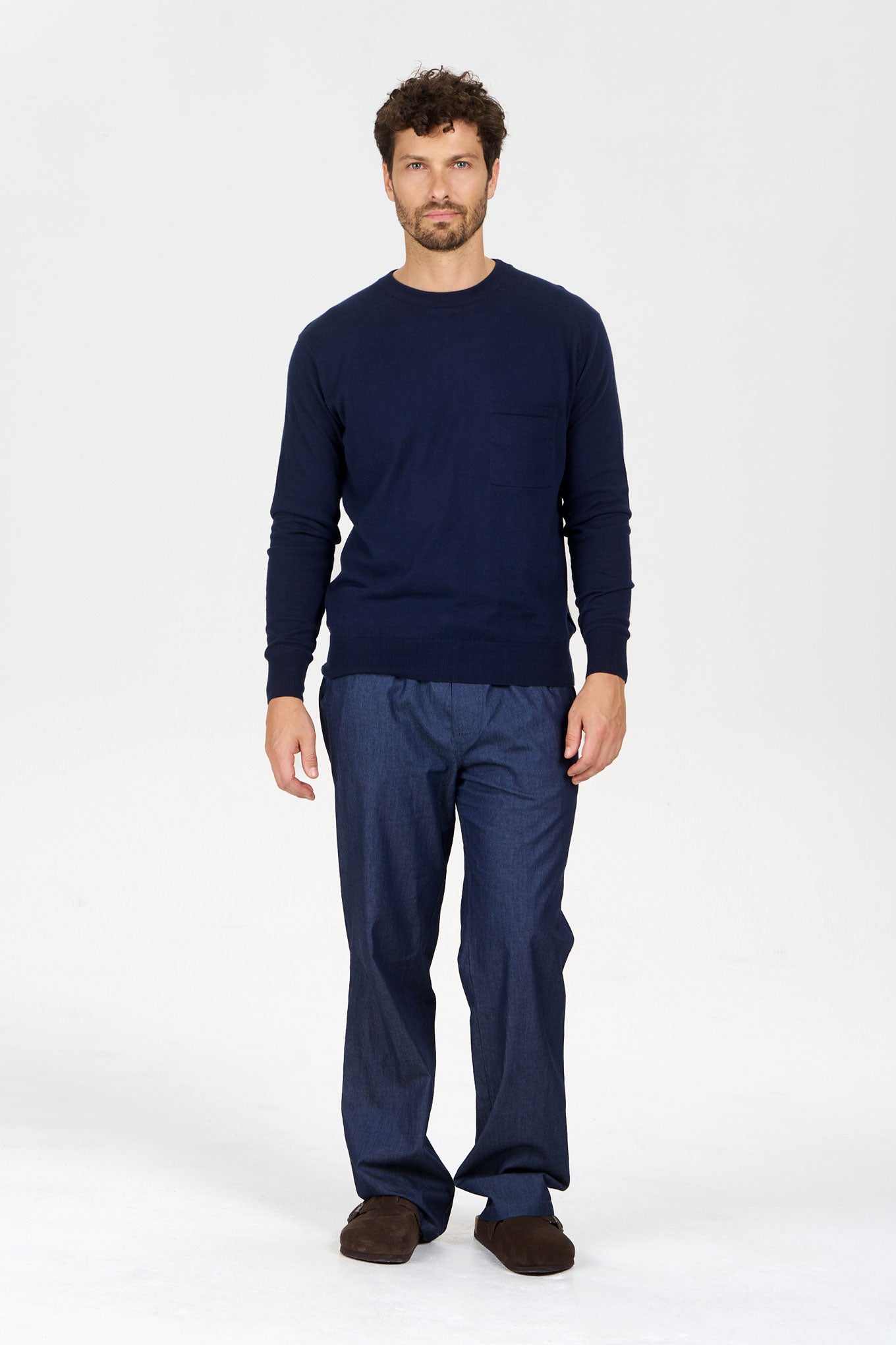 Man wearing POCKET GOTS Organic Cotton Jumper Navy with relaxed-fit style and comfortable pants.