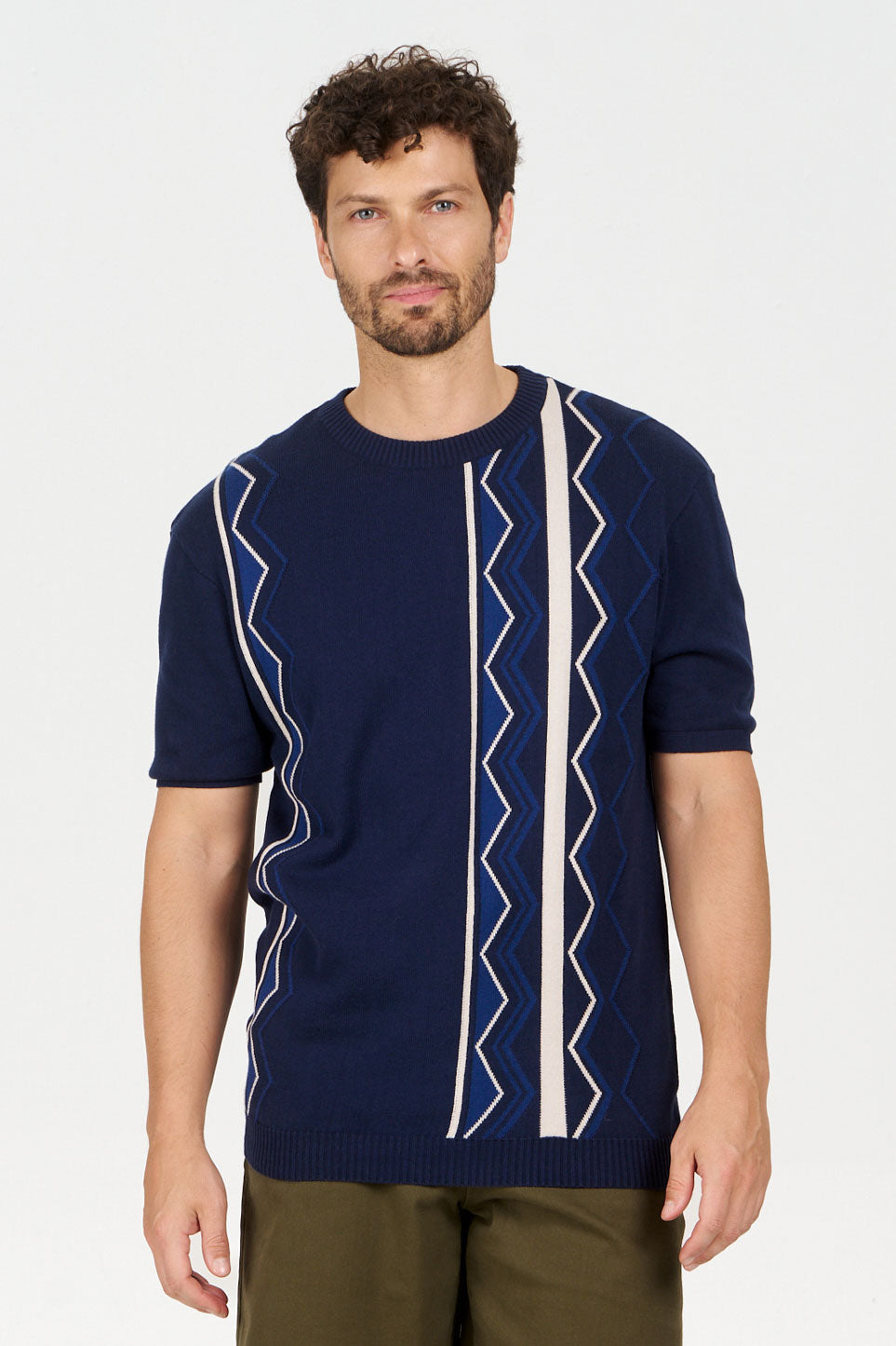 Model wearing RAFFI Organic Cotton Tee, a navy blue tee with geometric designs and a relaxed fit for casual summer wear.