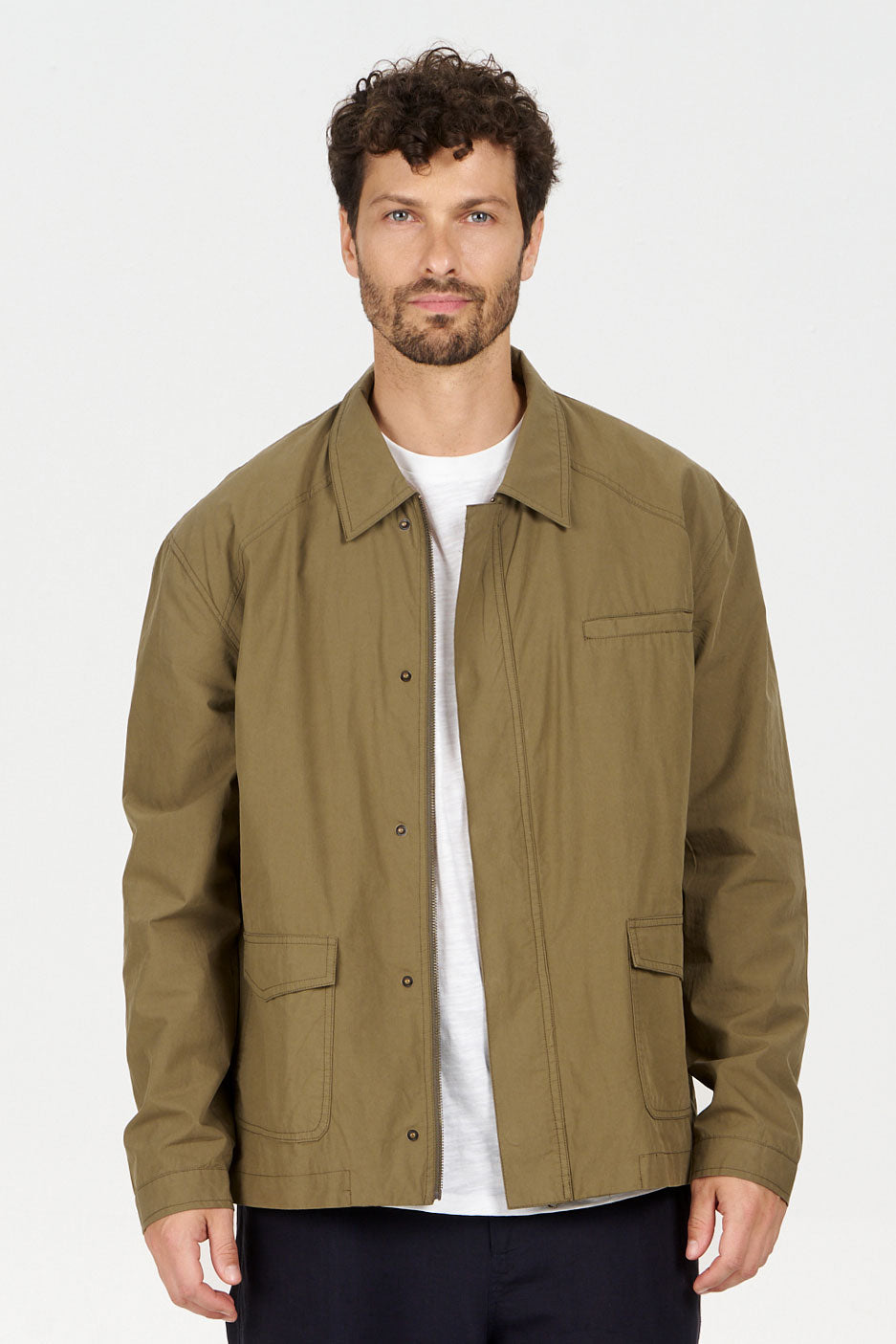 RUDY Organic Cotton Jacket - Olive worn by a man showcasing a lightweight, loose fit design.