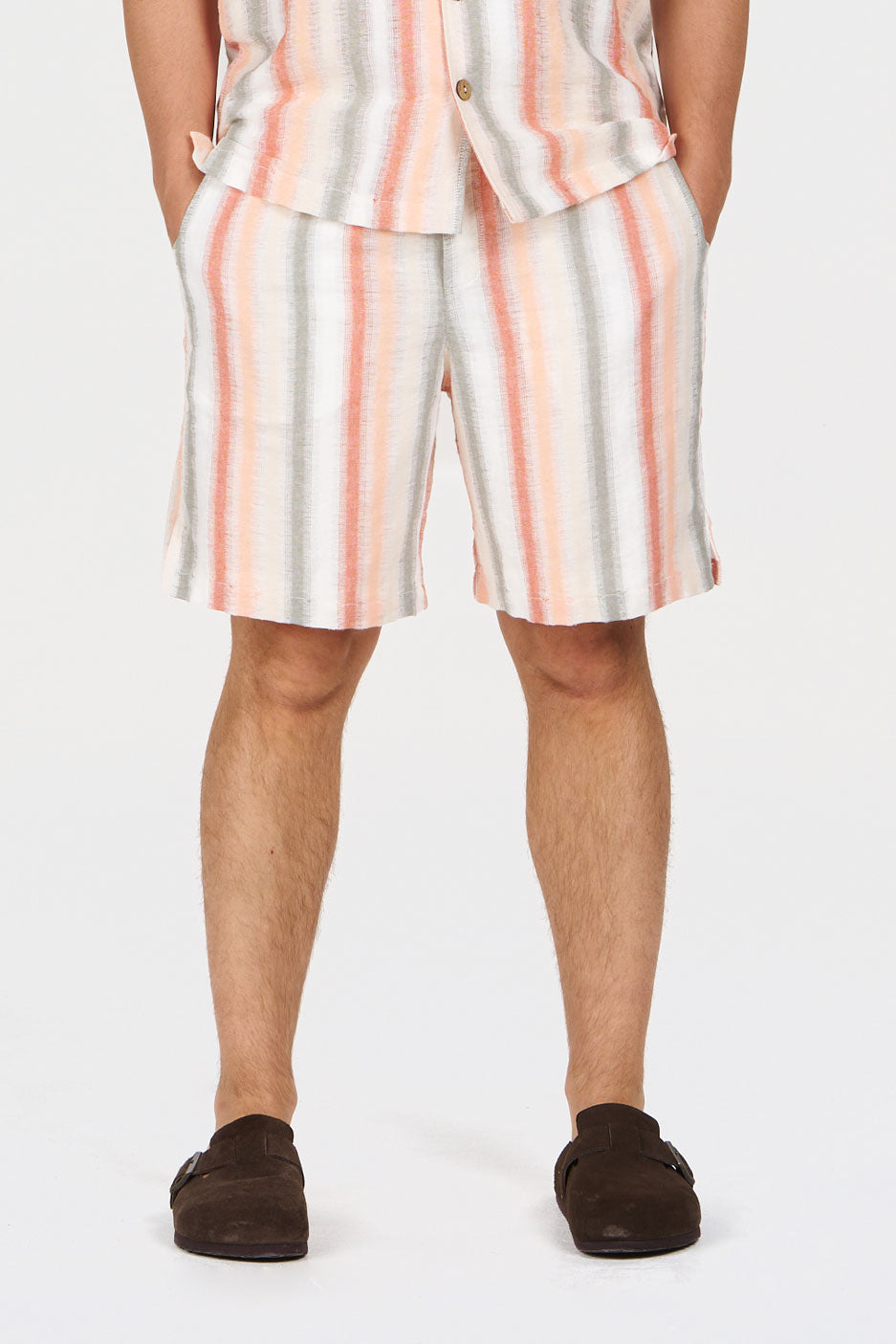 TOM Organic Cotton Short - stripe model wearing lightweight striped shorts with a loose fit, ideal for warm weather.