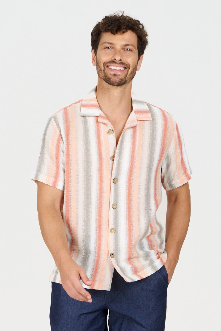 WAVE Organic Cotton Shirt displayed on a smiling man wearing a loose fit striped shirt with buttons.
